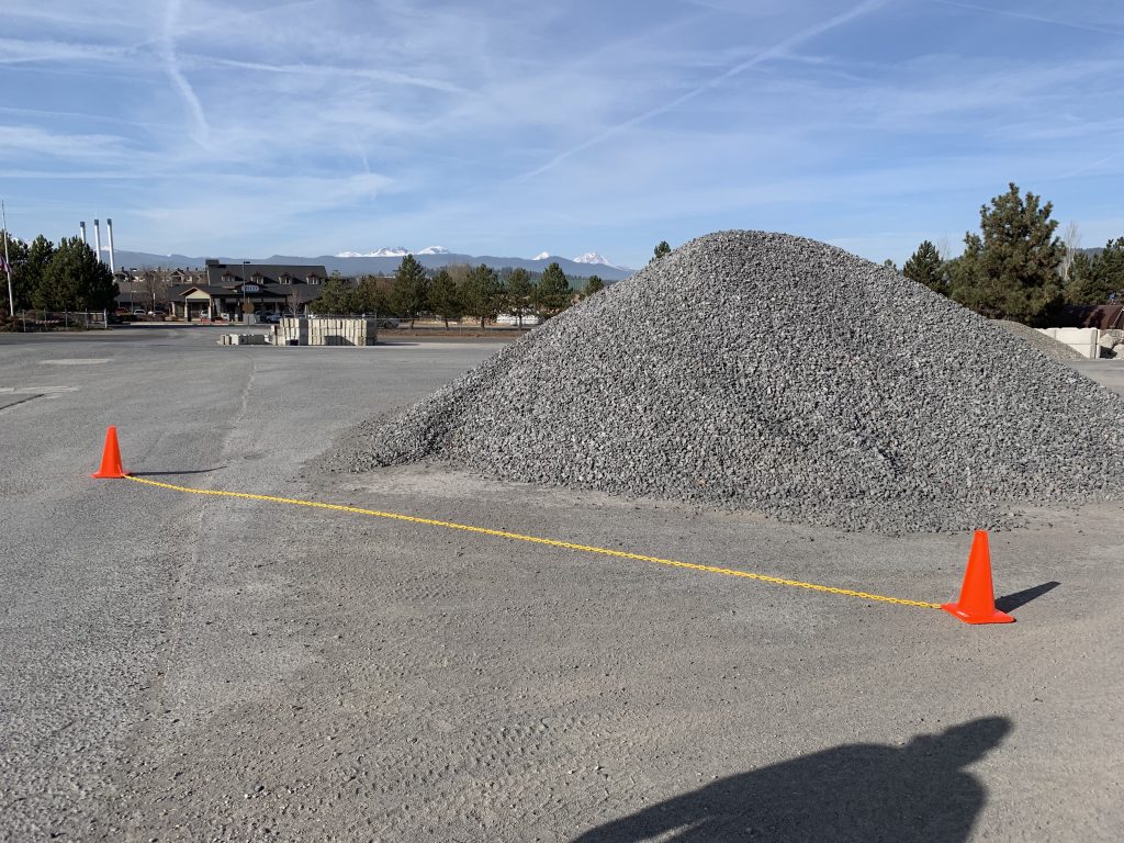 Orange safety cones placed around a stockpile for improved measurement accuracy