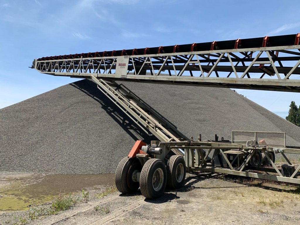 Heavy equipment near stockpile — obstruction that affects measurement accuracy